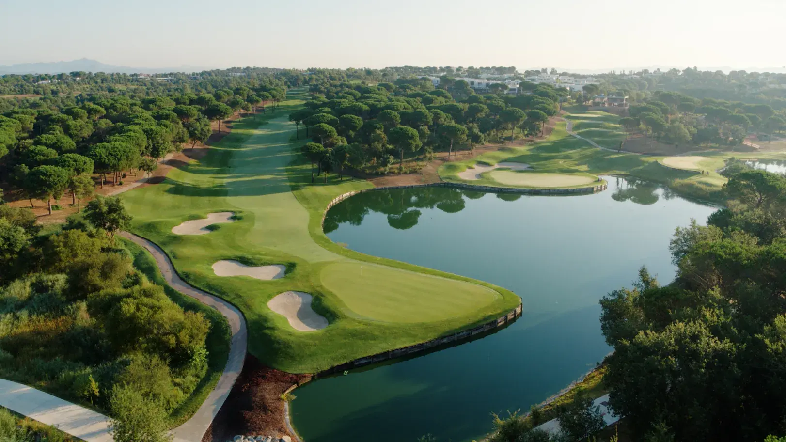 Aerial view of a lakeside hole at Camiral