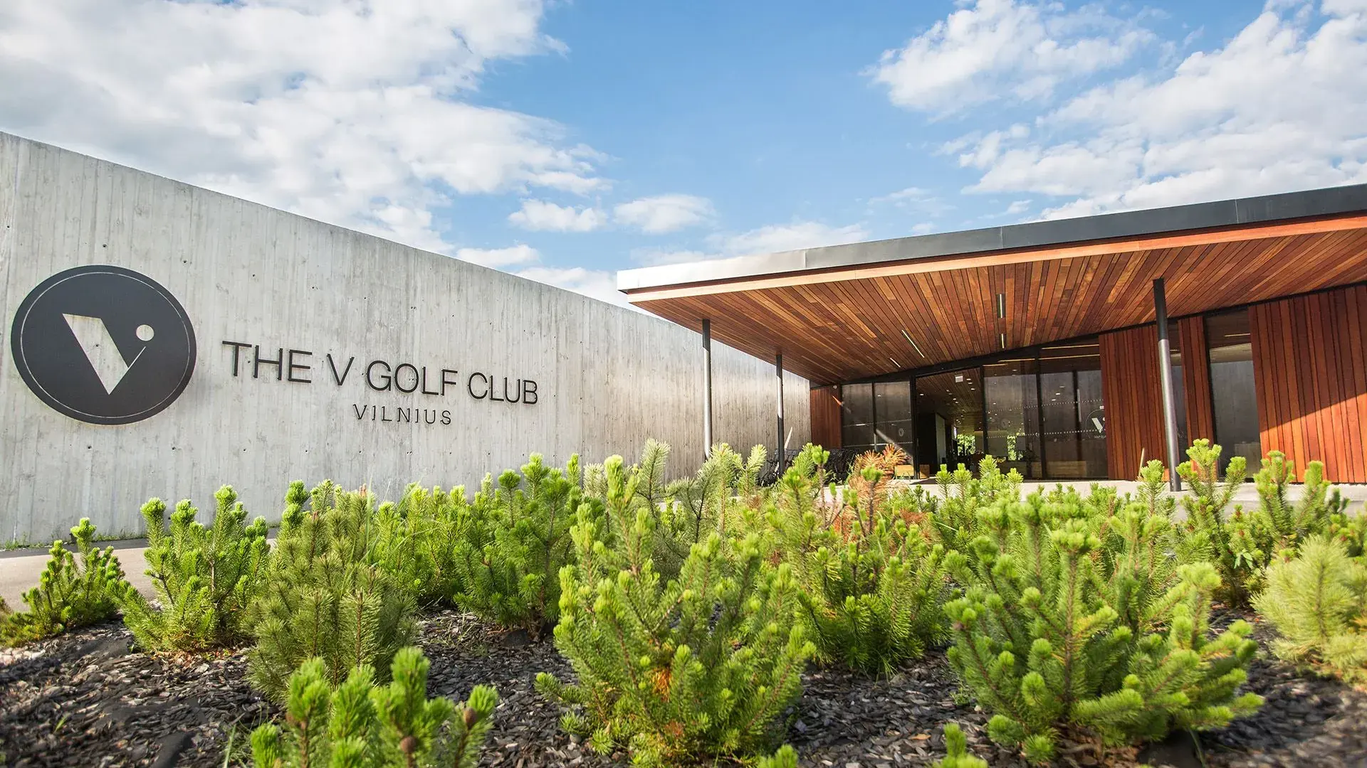 Entrance to The V Golf Club clubhouse beneath a timber canopy
